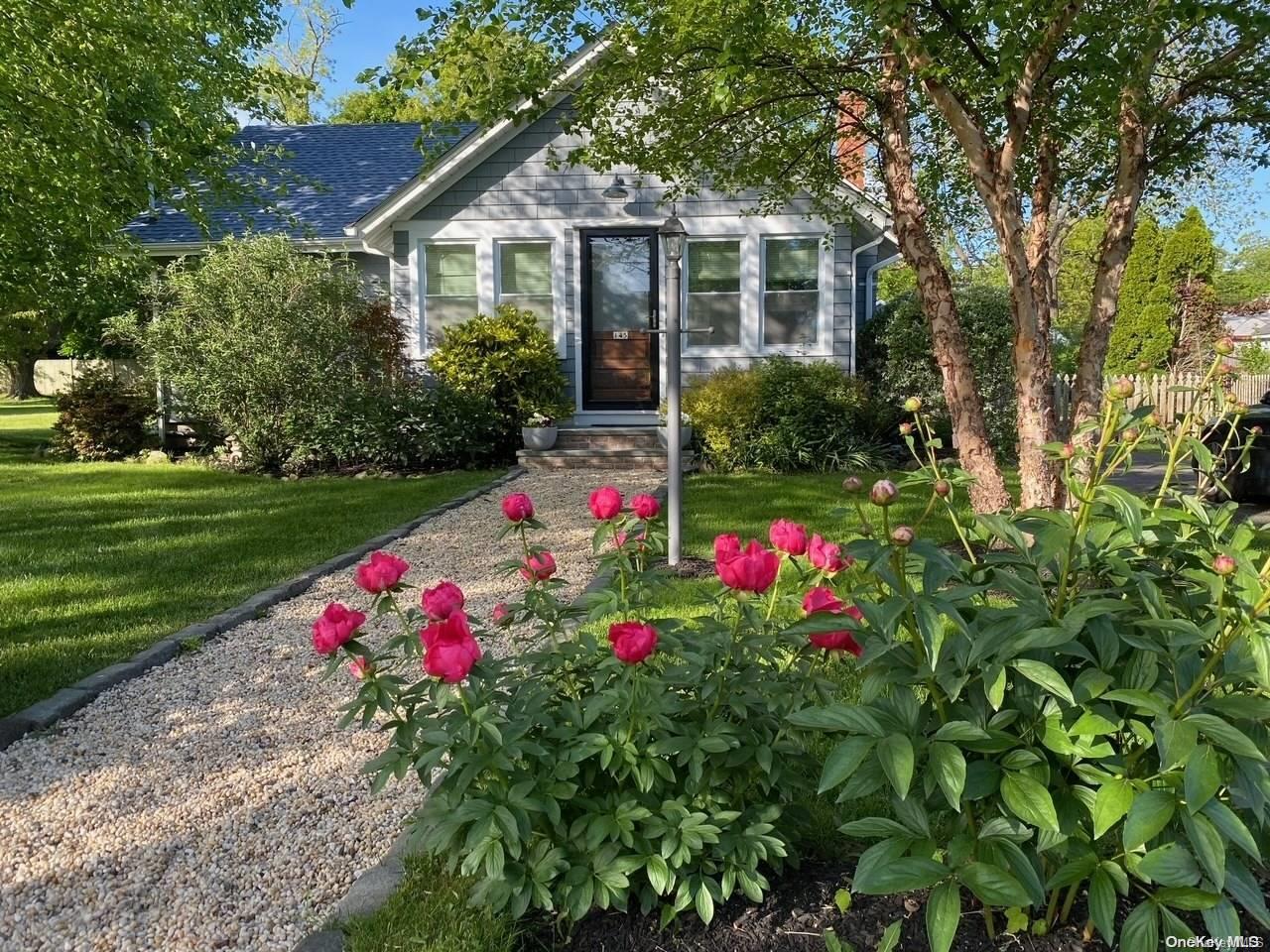 145 Founders Path Southold, NY 11971 - Photo 1 of 1 a front view of a house with a big yard and potted plants