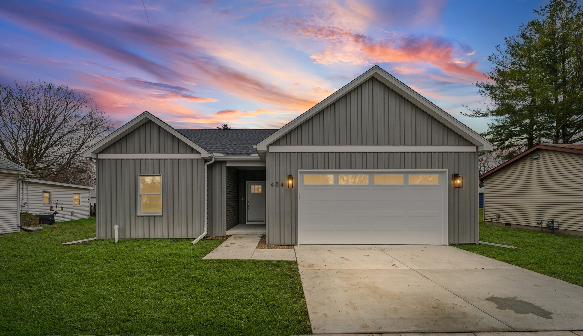 a front view of a house with a yard and garage