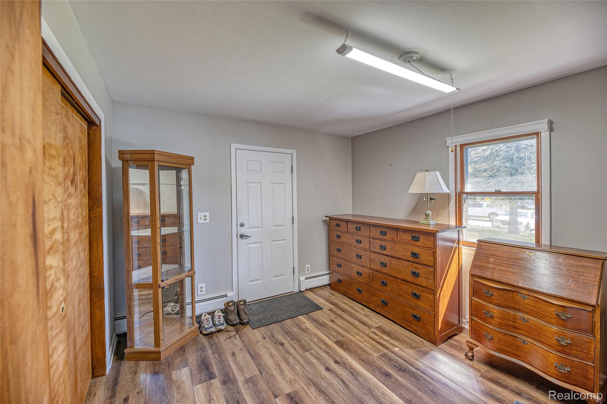 2855 Farmers Creek Road Metamora, MI 48455 - Photo 26 of 51 Entryway featuring wood-finish flooring, a white paneled door, and a single window with white trim