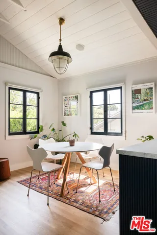 a workspace with furniture window and wooden floor