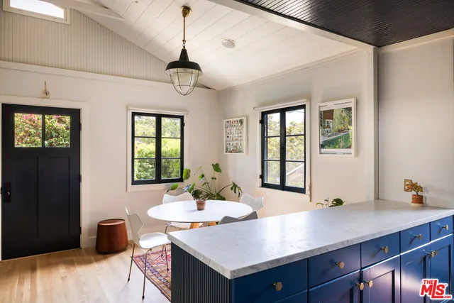 a view of a dining room with furniture and window