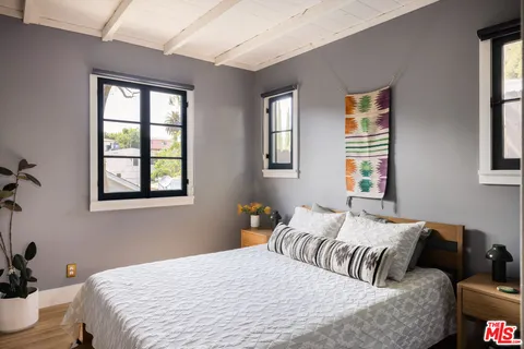 a bedroom with bed couch and window