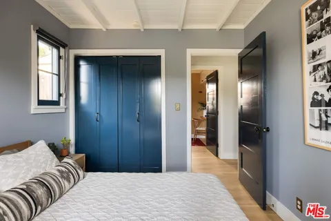 a bedroom with a bed and glass door