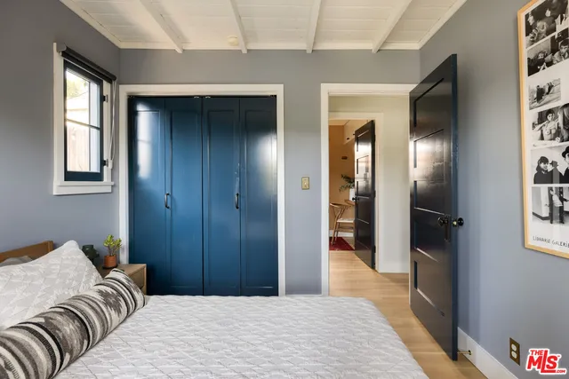 a bedroom with a bed and glass door