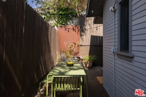 a view of a patio with table and chairs and wooden floor