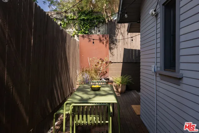 a view of a patio with table and chairs and wooden floor