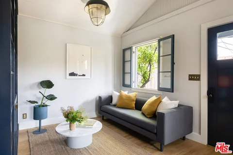 a living room with furniture and a potted plant