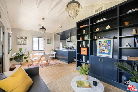 a living room with furniture cabinets and a flat screen tv