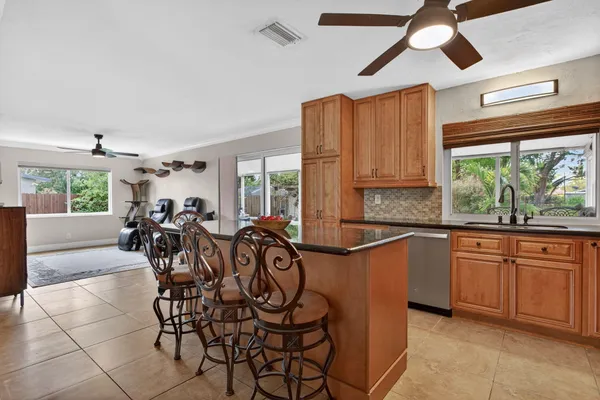 a very nice looking kitchen with a large window appliances and furniture