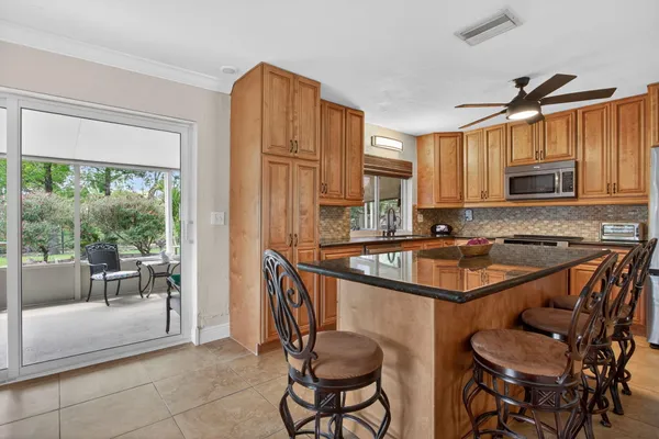 a kitchen with granite countertop a sink and a refrigerator