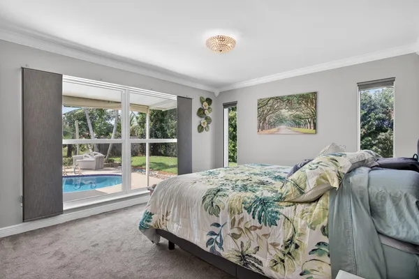 a bed sitting in a bedroom next to a window