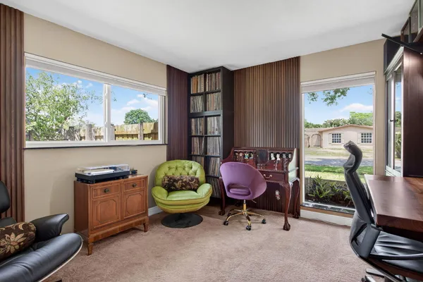 a living room with furniture a window and a flat screen tv