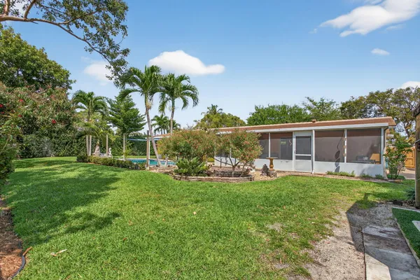 a view of a house with backyard sitting area and garden