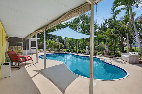 a view of a swimming pool with back yard