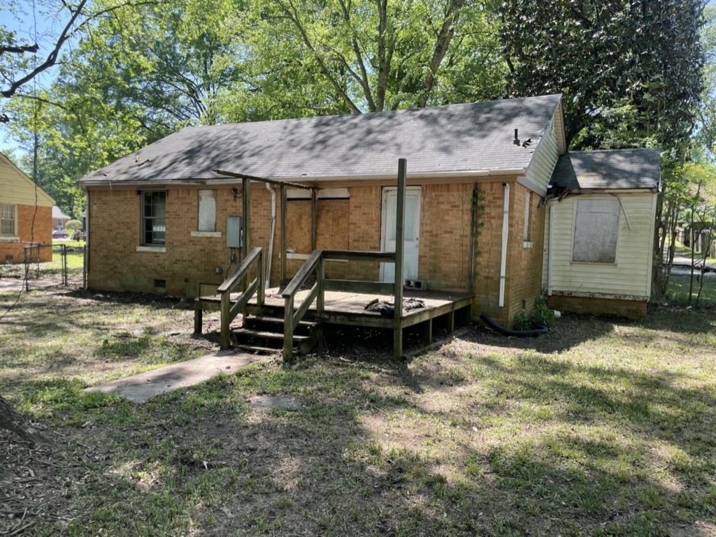 966 Goodman Street Memphis, TN 38111 - Photo 24 of 25 a backyard of a house with table and chairs under an umbrella