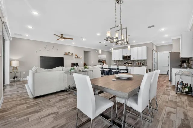 a spacious bedroom with a large bed and a chandelier