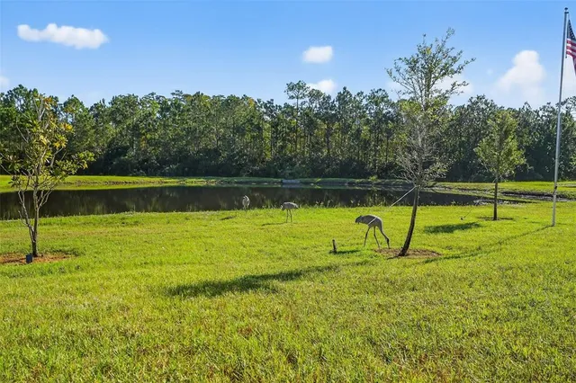a view of a lake with a bench in front of house