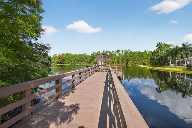 an aerial view of a house with yard swimming pool and lake view