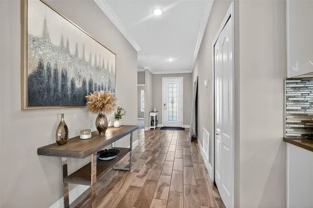 a kitchen with stainless steel appliances granite countertop a stove a sink a microwave a refrigerator and white cabinets