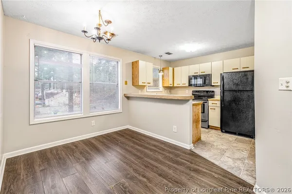 a kitchen with stainless steel appliances a refrigerator sink and cabinets