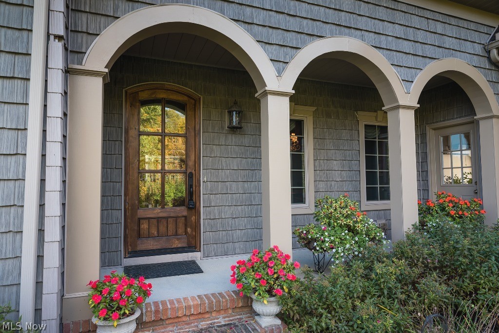 16277 Snyder Road Chagrin Falls, OH 44022 - Photo 3 of 35 The front porch welcomes you with detailed archways and a craftsman wood door.