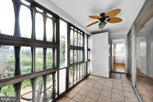 a bedroom with a large bed and a large window