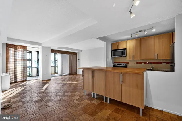 a large kitchen with cabinets table and chairs