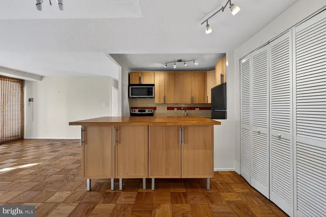a view of a kitchen with a sink and a refrigerator