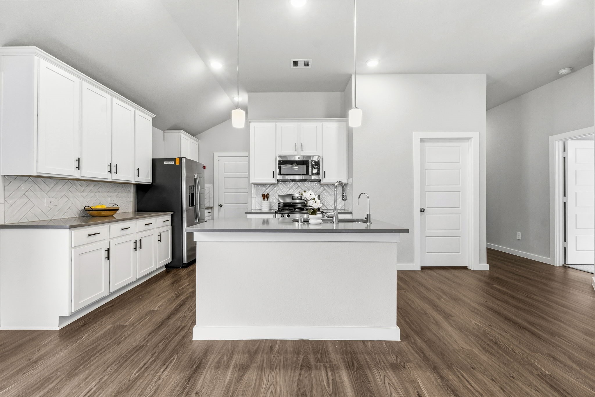 22235 Cardinal Crest Lane New Caney, TX 77357 - Photo 5 of 41 Beautiful kitchen featuring upgraded cabinetry, ample counter space, and an open design that flows seamlessly into the dining and family room.