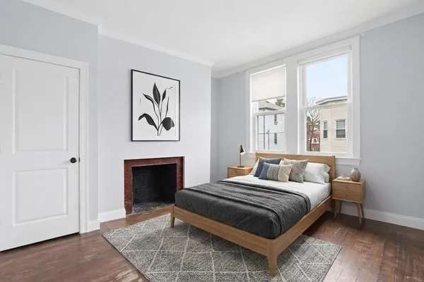 a bedroom with a bed and a fireplace