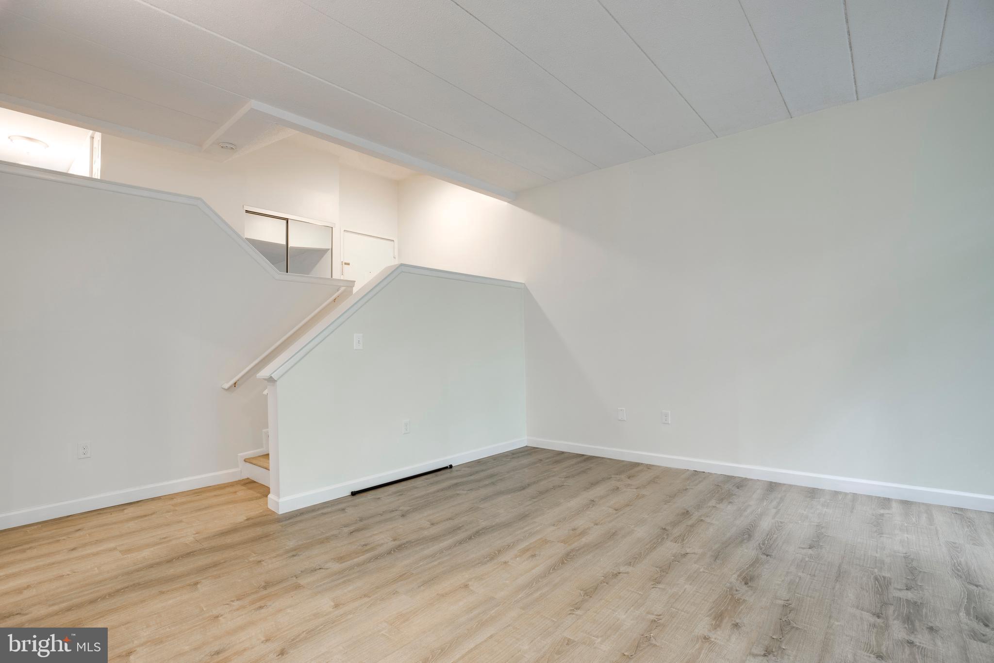2106 Green Watch Way, Unit 101 Reston, VA 20191 - Photo 11 of 40 a view of an empty room with wooden floor