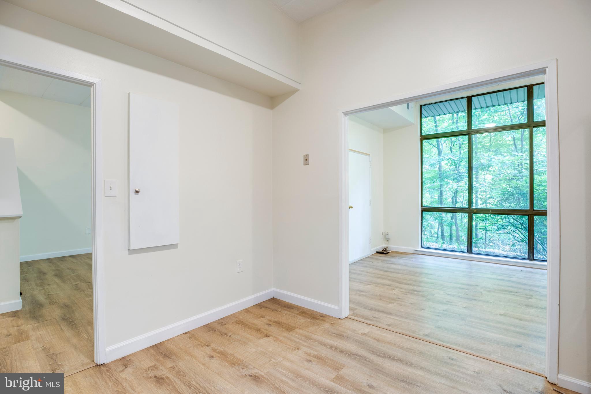 2106 Green Watch Way, Unit 101 Reston, VA 20191 - Photo 18 of 40 an empty room with wooden floor and windows