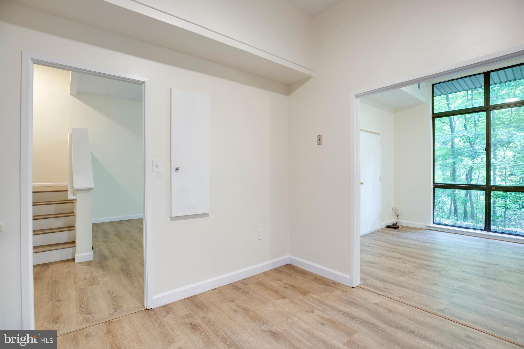 2106 Green Watch Way, Unit 101 Reston, VA 20191 - Photo 19 of 40 wooden floor in an empty room with a window