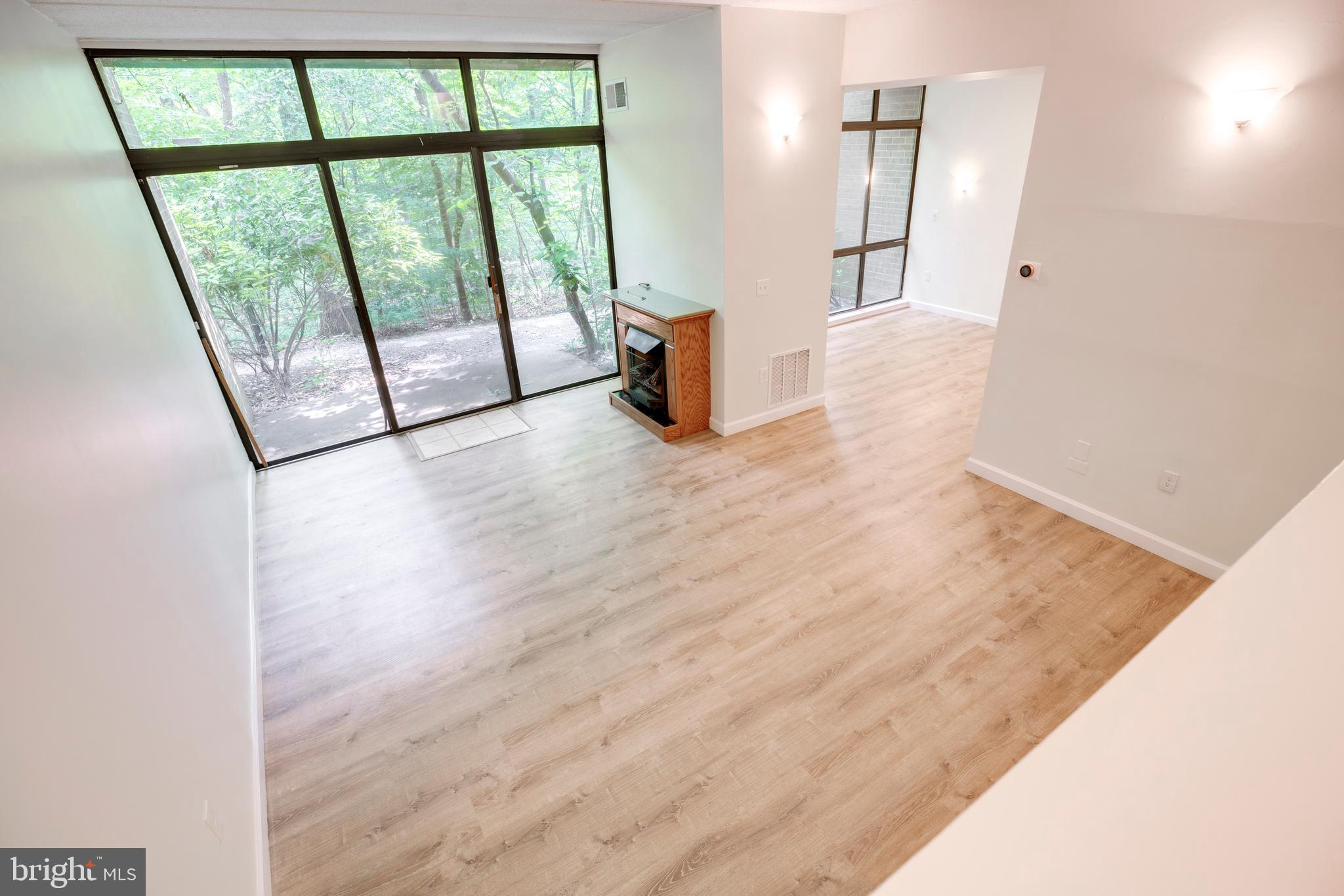 2106 Green Watch Way, Unit 101 Reston, VA 20191 - Photo 21 of 40 an empty room with wooden floor and windows