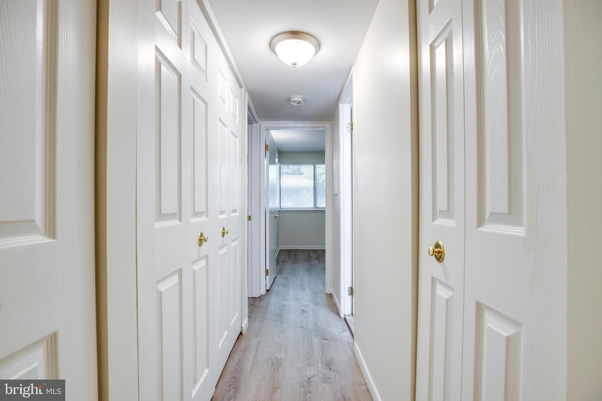 2106 Green Watch Way, Unit 101 Reston, VA 20191 - Photo 22 of 40 a view of a hallway with wooden floor