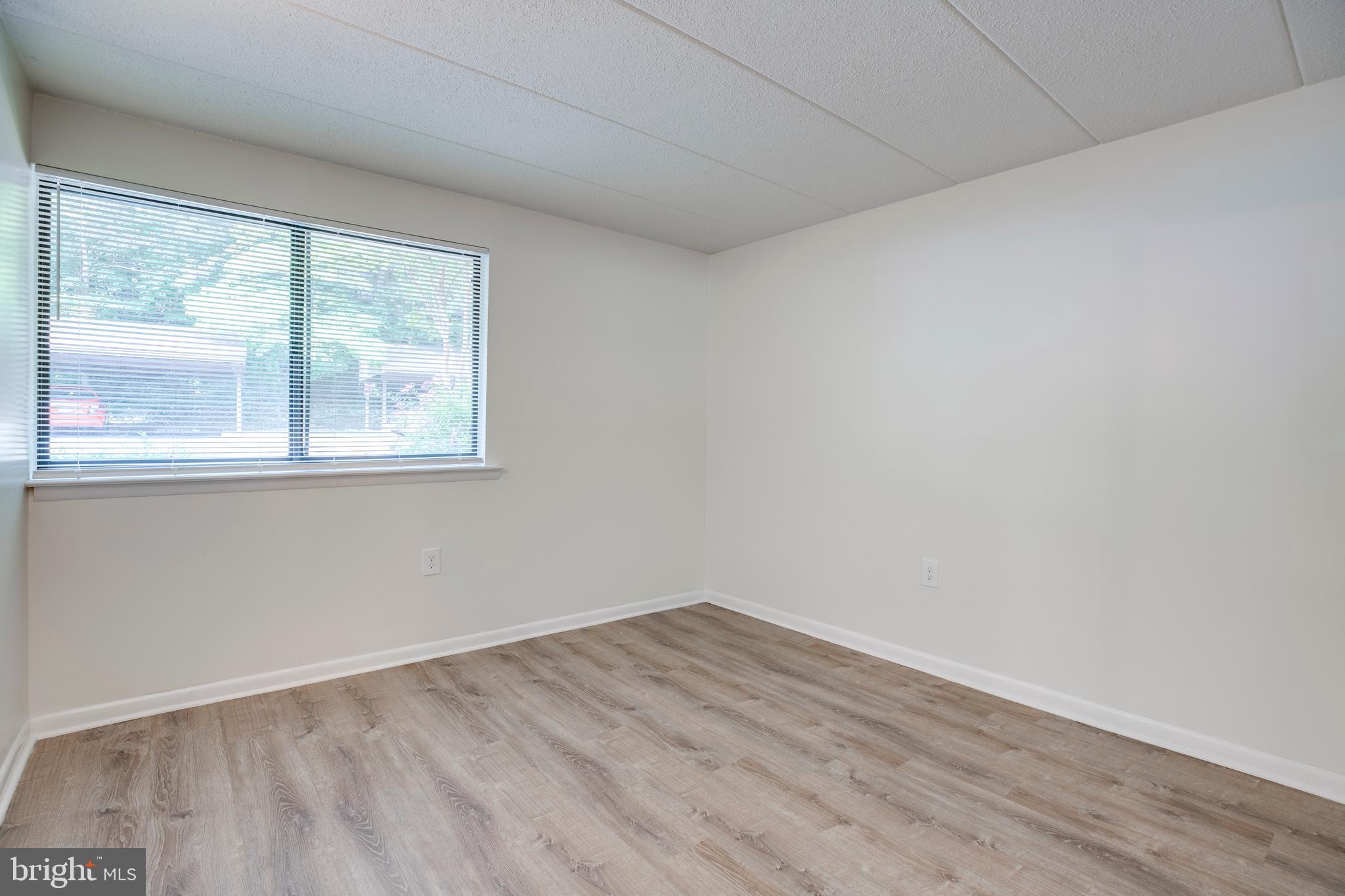 2106 Green Watch Way, Unit 101 Reston, VA 20191 - Photo 25 of 40 wooden floor in an empty room with a window