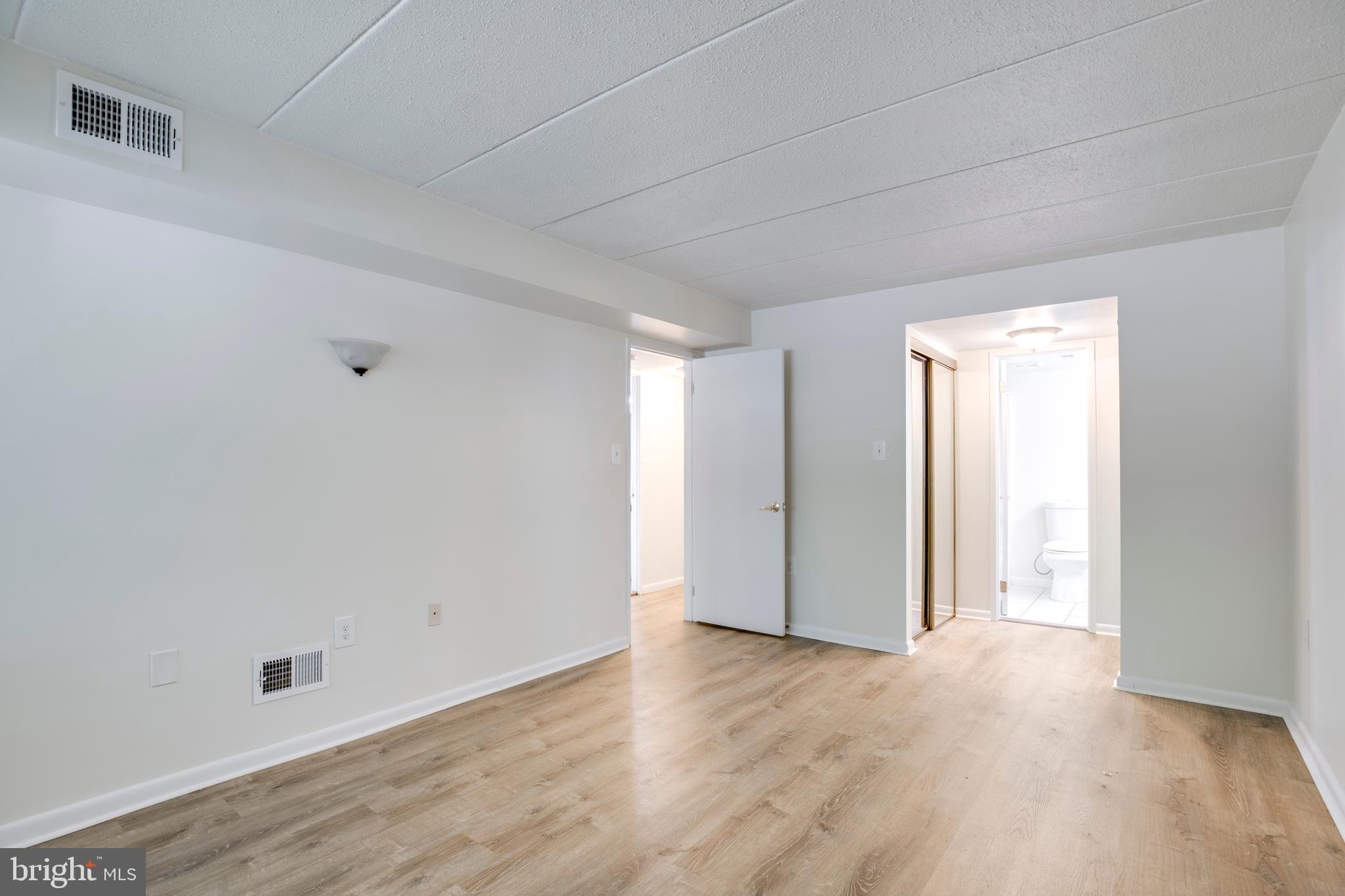 2106 Green Watch Way, Unit 101 Reston, VA 20191 - Photo 29 of 40 a view of an empty room and wooden floor