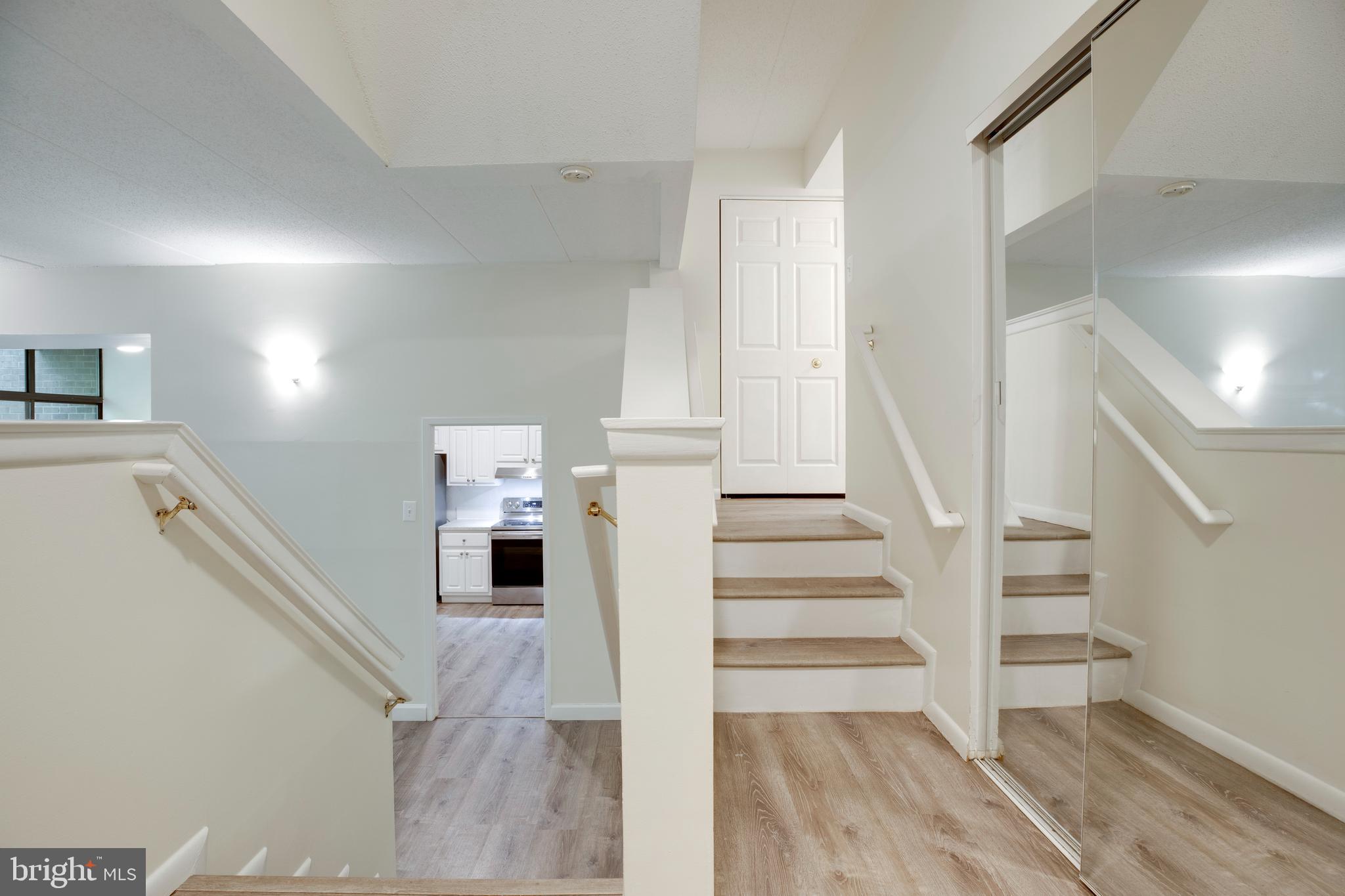 2106 Green Watch Way, Unit 101 Reston, VA 20191 - Photo 3 of 40 a view of a hallway with wooden floor and entryway