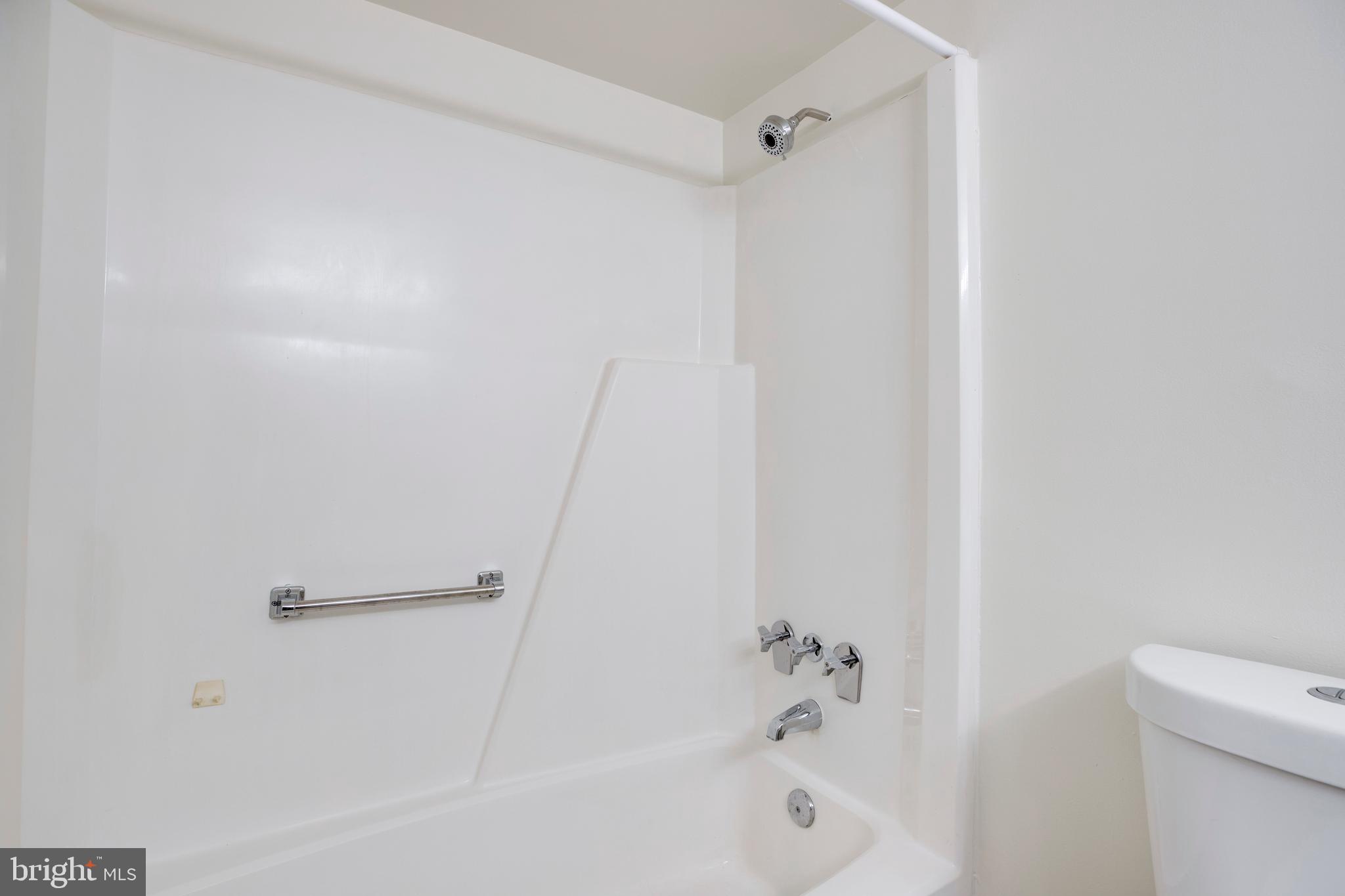 2106 Green Watch Way, Unit 101 Reston, VA 20191 - Photo 32 of 40 a bathroom with a shower and a bath tub