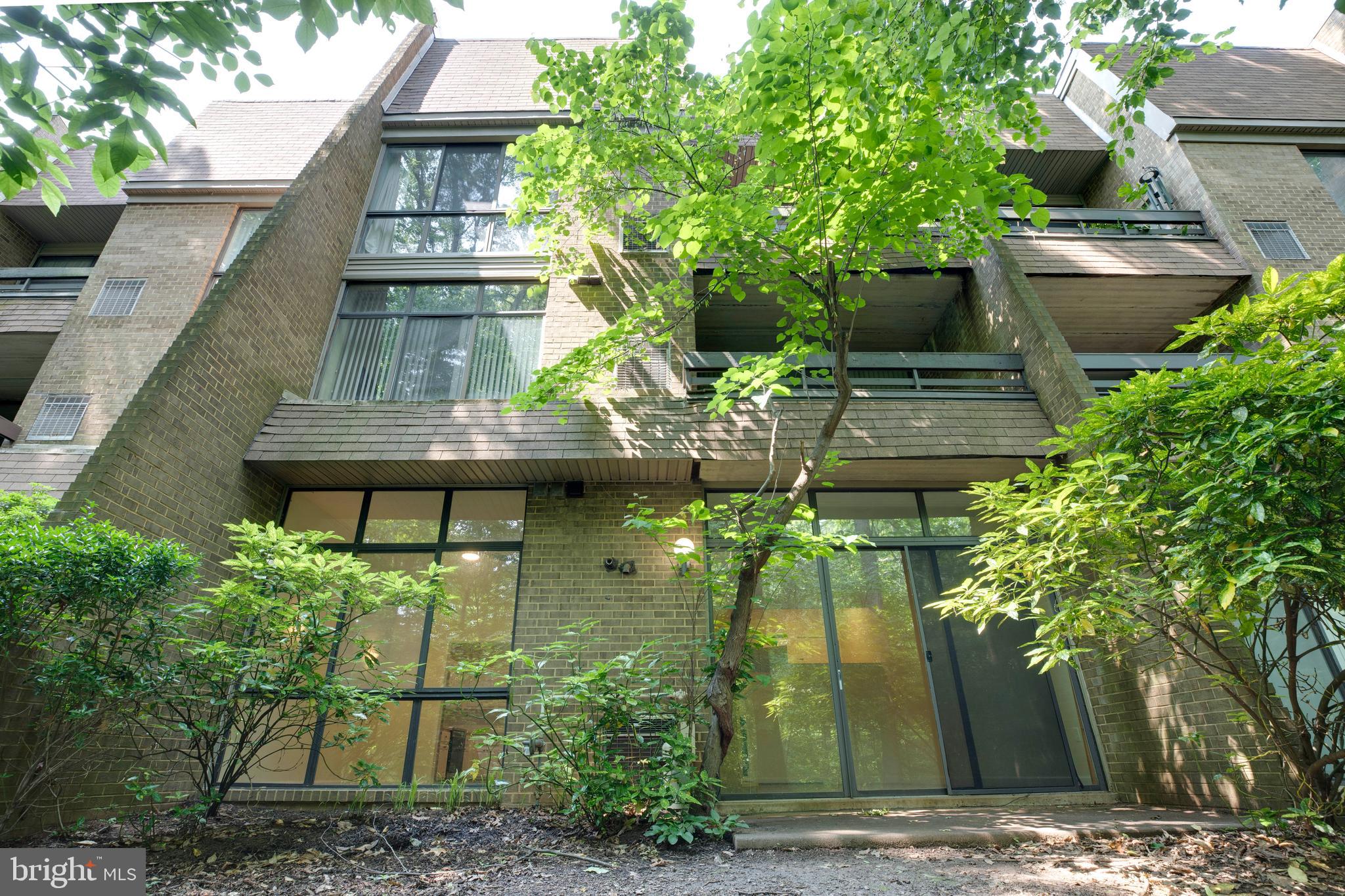 2106 Green Watch Way, Unit 101 Reston, VA 20191 - Photo 34 of 40 a backyard of a house with lots of green space