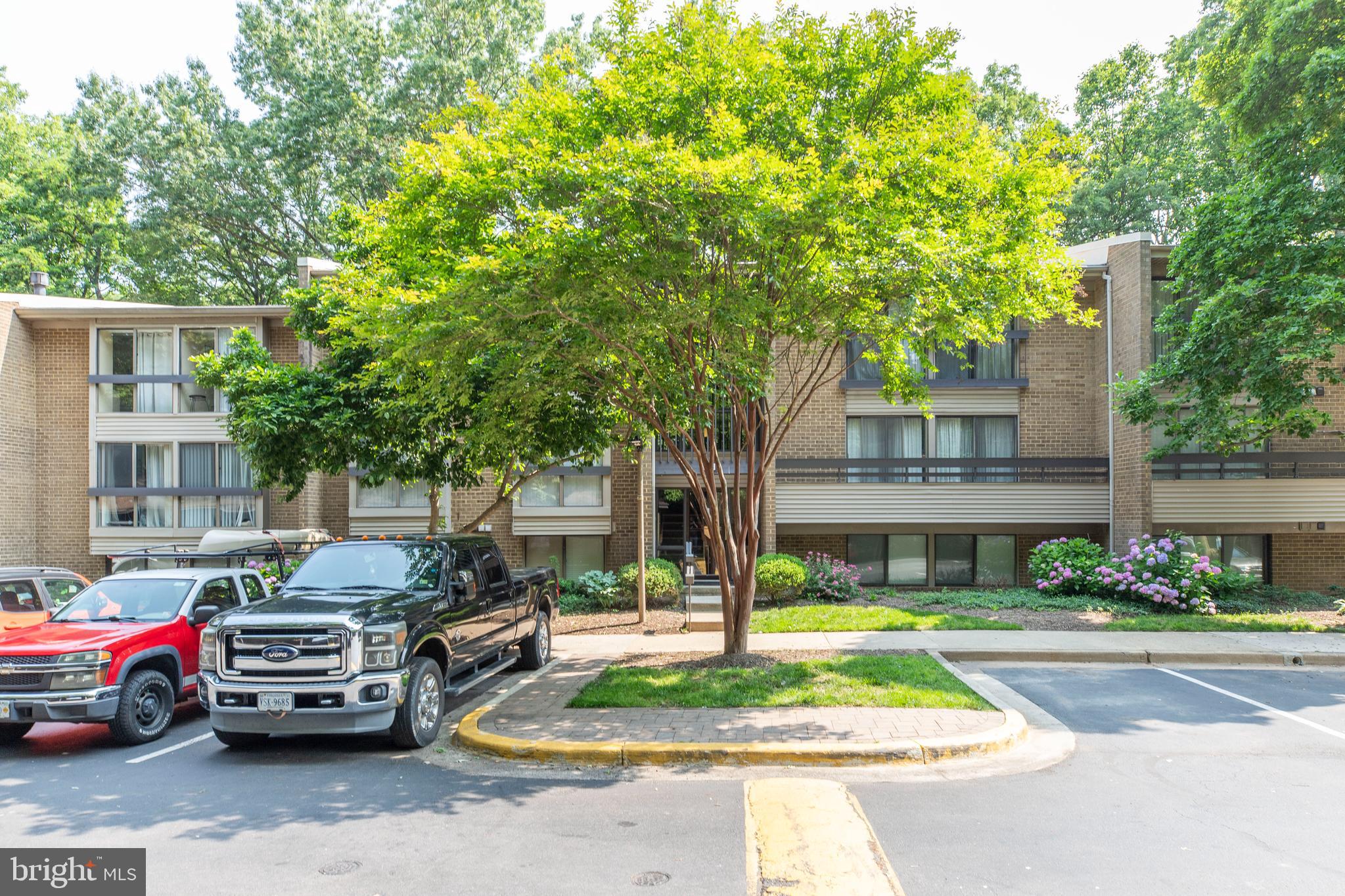 2106 Green Watch Way, Unit 101 Reston, VA 20191 - Photo 38 of 40 a front view of a house with a yard table and chairs