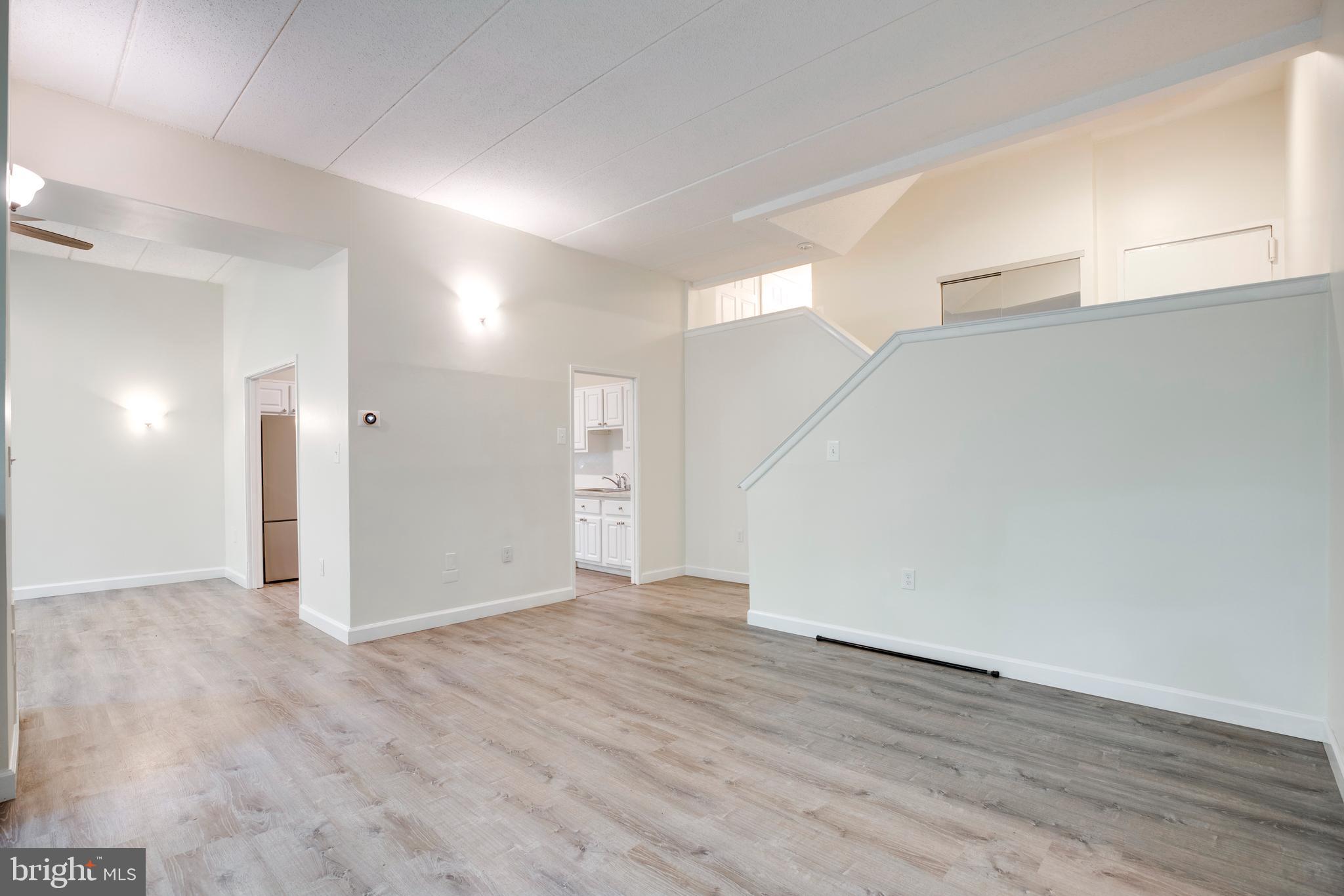 2106 Green Watch Way, Unit 101 Reston, VA 20191 - Photo 10 of 40 a view of empty room with wooden floor