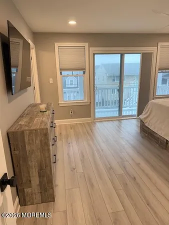 a room with a bed and a television