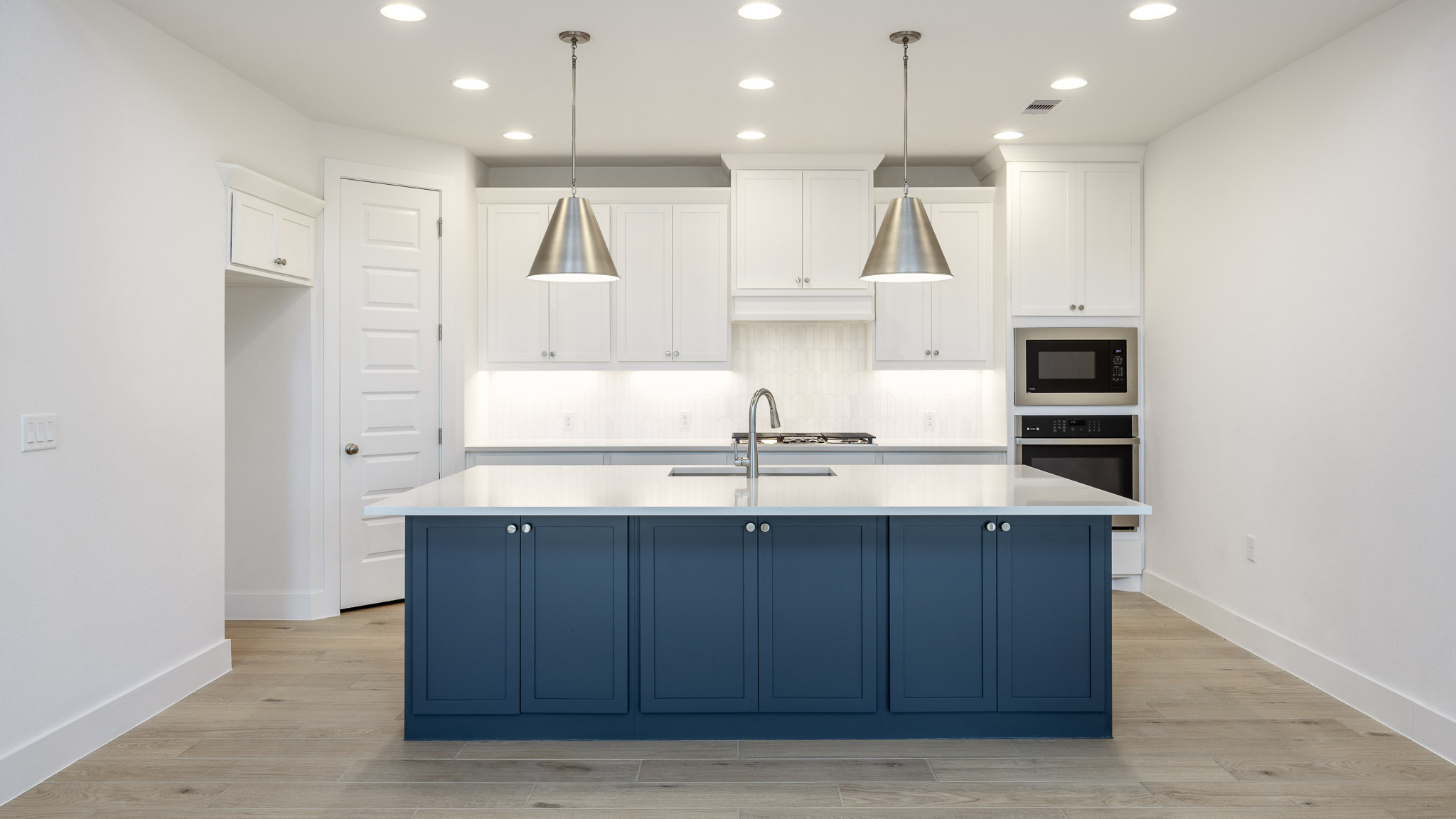7002 Woodford Way Austin, TX 78744 - Photo 5 of 22 a kitchen with kitchen island a sink stainless steel appliances and cabinets