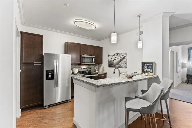 a kitchen with kitchen island a sink stove and refrigerator