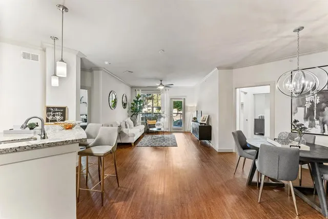 a very nice looking living room with wooden floor and furniture