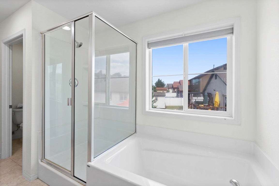 11221 Mickelson Drive Austin, TX 78747 - Photo 15 of 28 a bathroom with a bathtub and a shower