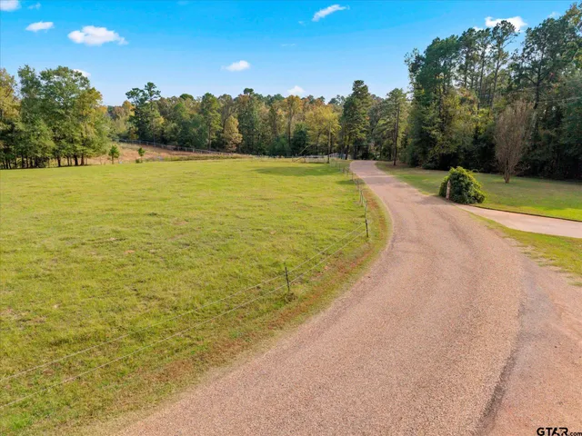 a view of a swimming pool and trees in the background