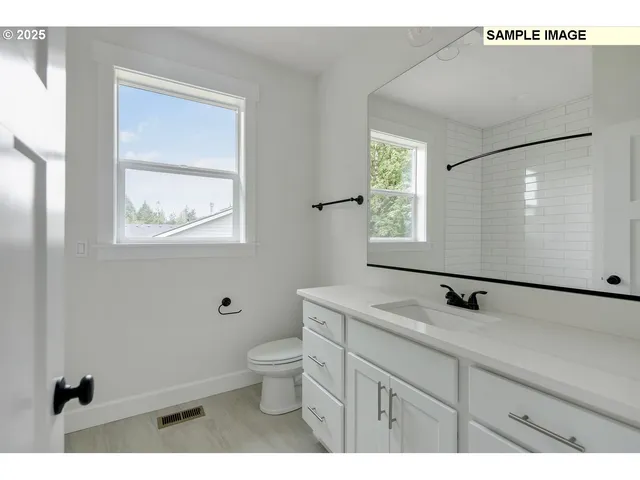 a bathroom with a sink a toilet and window