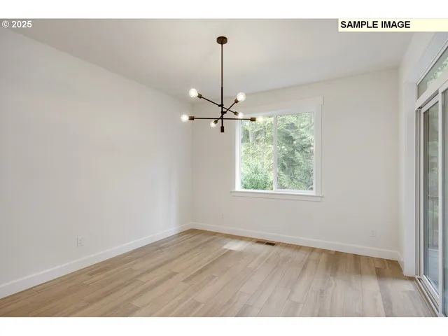 a view of a room with wooden floor fan and window